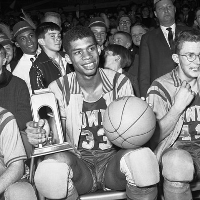 A teenage Kareem Abdul-Jabbar, then known as Lew Alcindor, proudly displays his