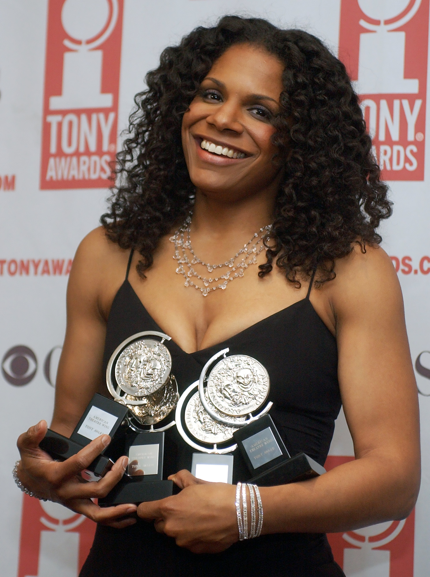 Audra McDonald displays her Tony Awards on the night she won her fourth, in 2004, as Best Featured Actress in a Play for her work in A Raisin in the Sun. (AP Images/Richard Drew)