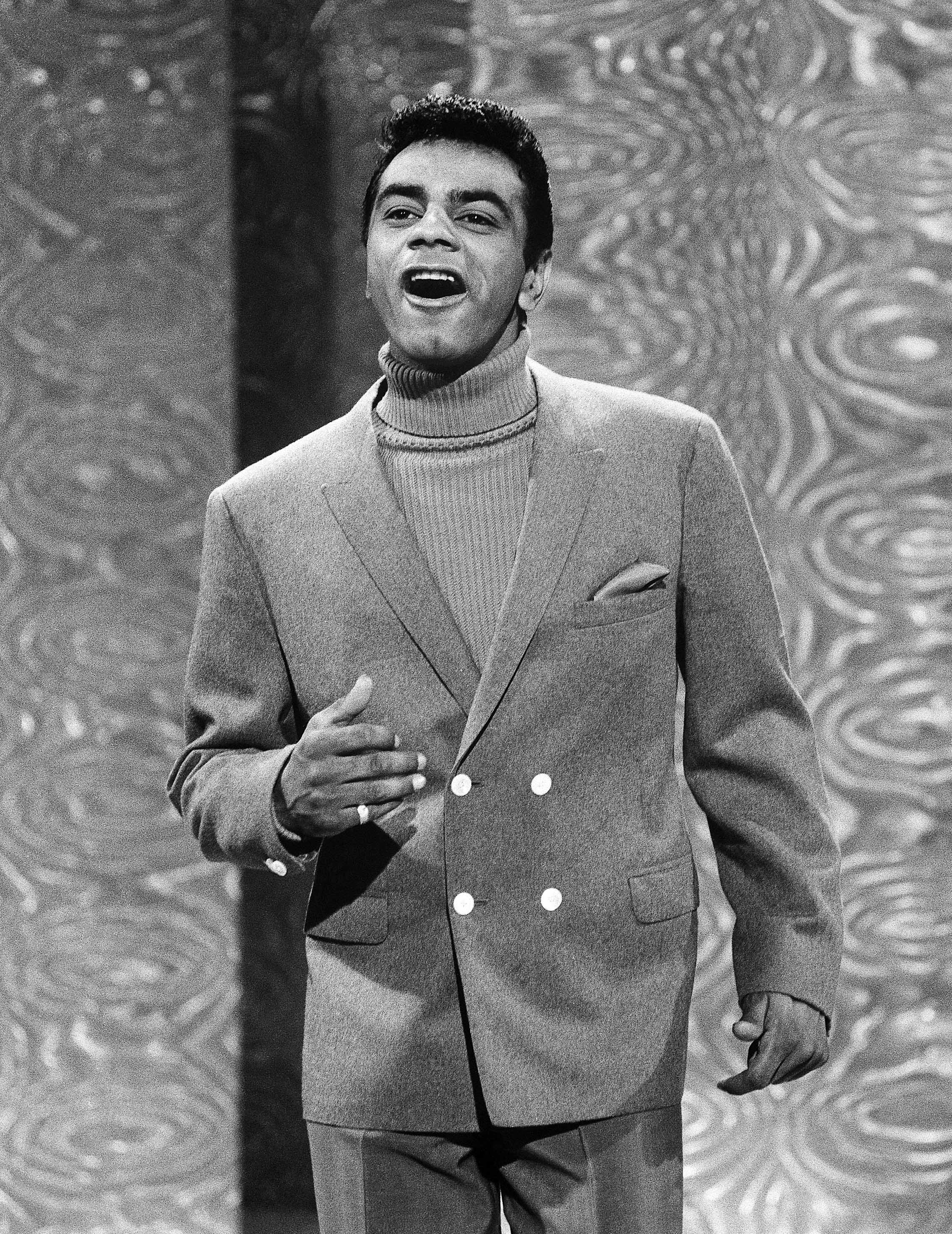 Johnny Mathis on the <i>Ed Sullivan Show</i> in 1967. His appearances on the popular Sunday night television program introduced him to a national audience in the 1950s, and he remained a frequent guest for the rest of the show's run. (© Bettmann/CORBIS)