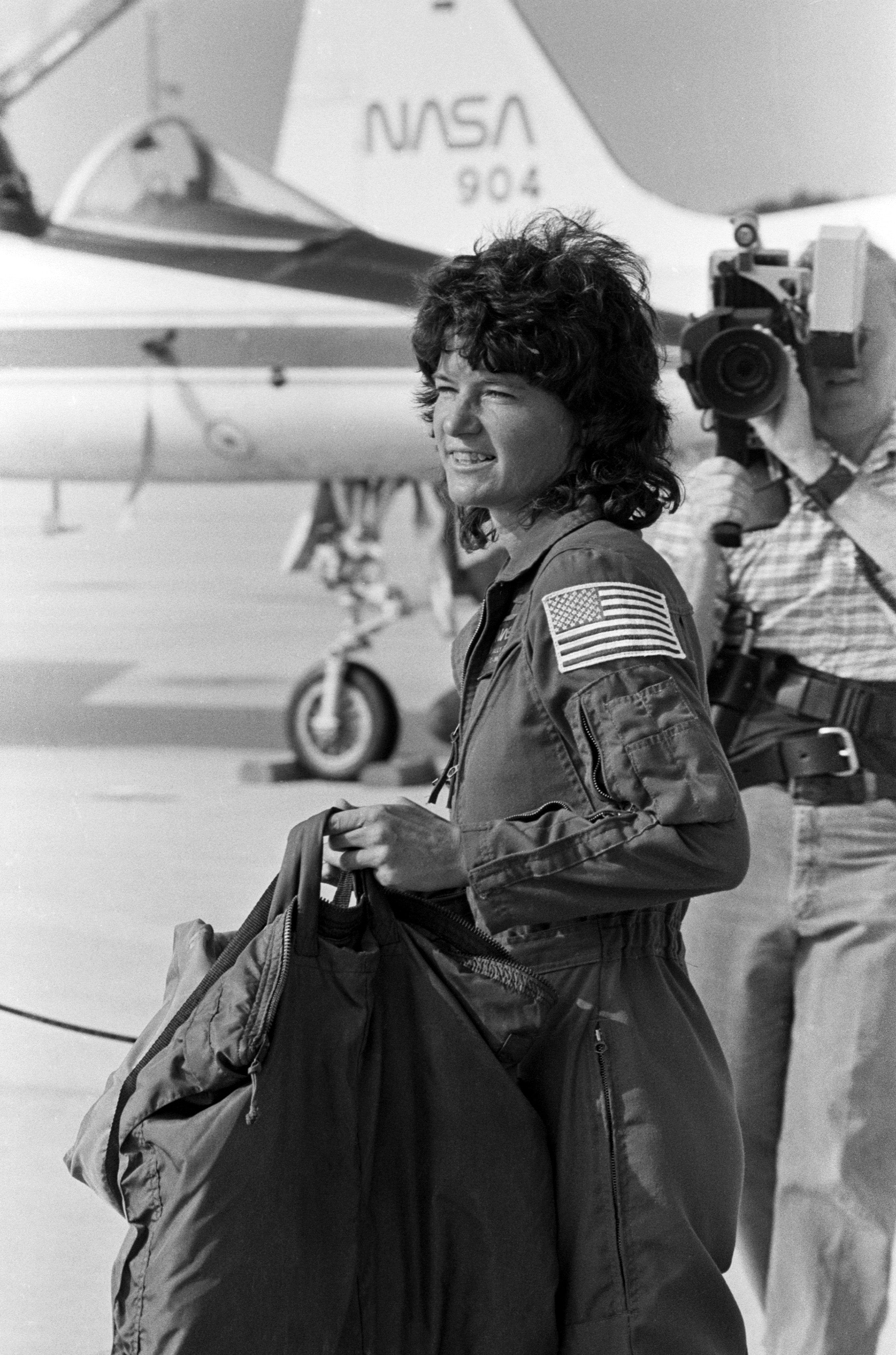 Mission specialist Sally Ride, the first American woman sent into space, totes her own luggage following her arrival at the Kennedy Space Center. (© Bettmann/CORBIS)