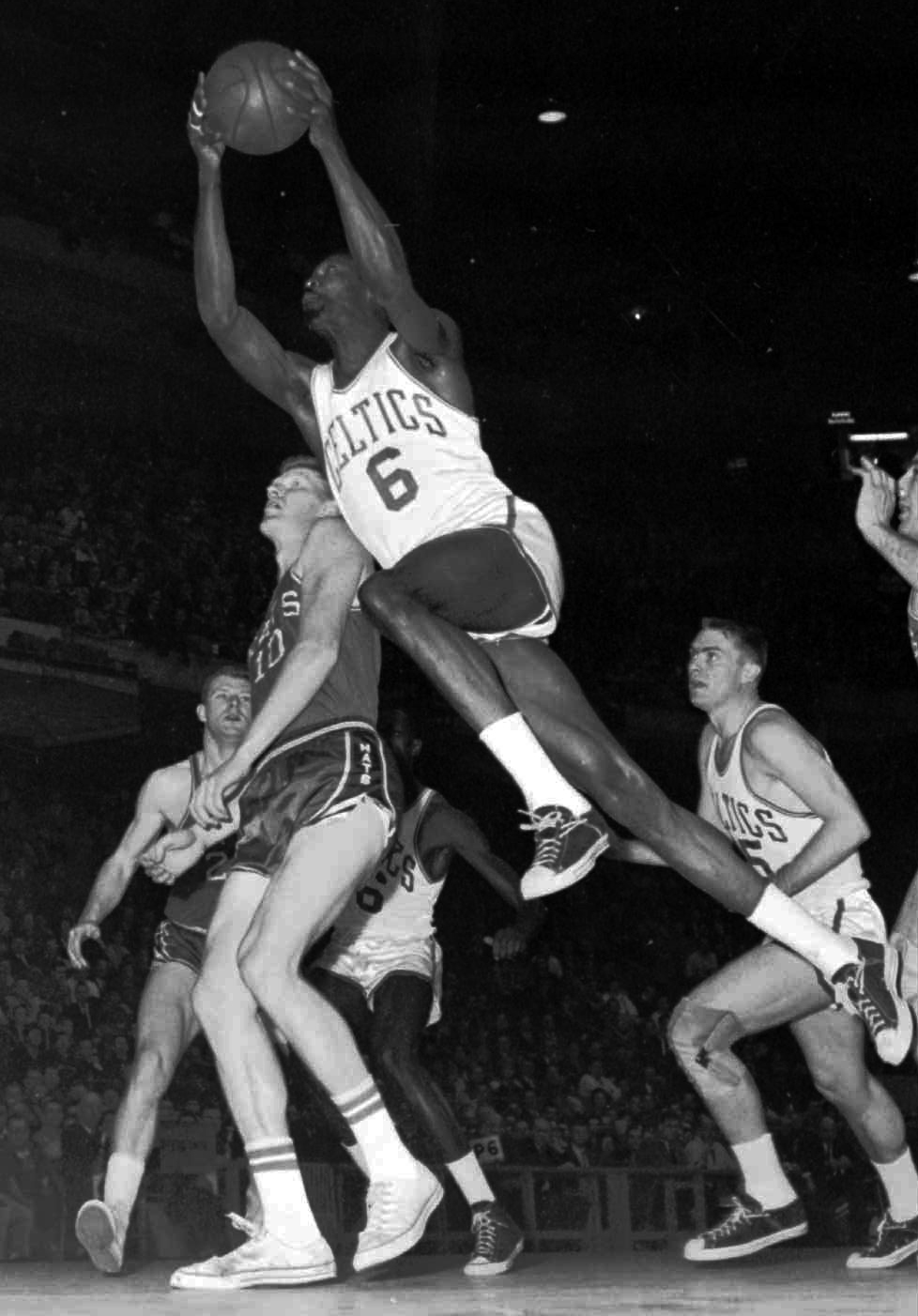 Bill Russell, Number 6, flies past the Syracuse Nationals defense in a 1963 game at Boston Garden. Year after year, Russell's Celtics bested the Nationals in the Eastern Division playoffs. (AP Images)