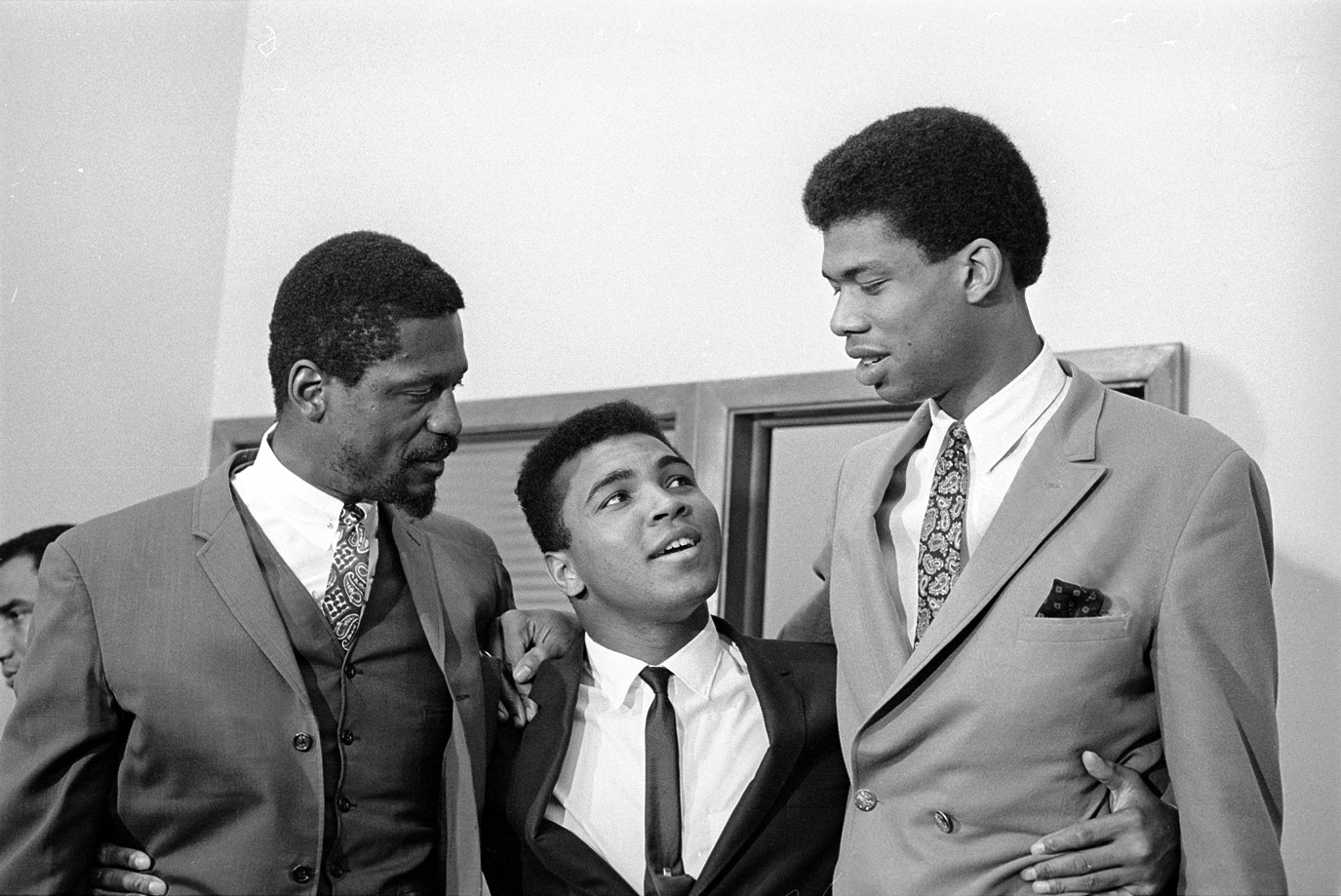 1967: Bill Russell of the Boston Celtics, and UCLA star Lew Alcindor (later known as Kareem Abdul-Jabbar) offer their support to heavyweight champion Muhammad Ali during his struggle to keep his title after refusing to serve in the U.S. military during the Vietnam War. (© Bettmann/CORBIS)