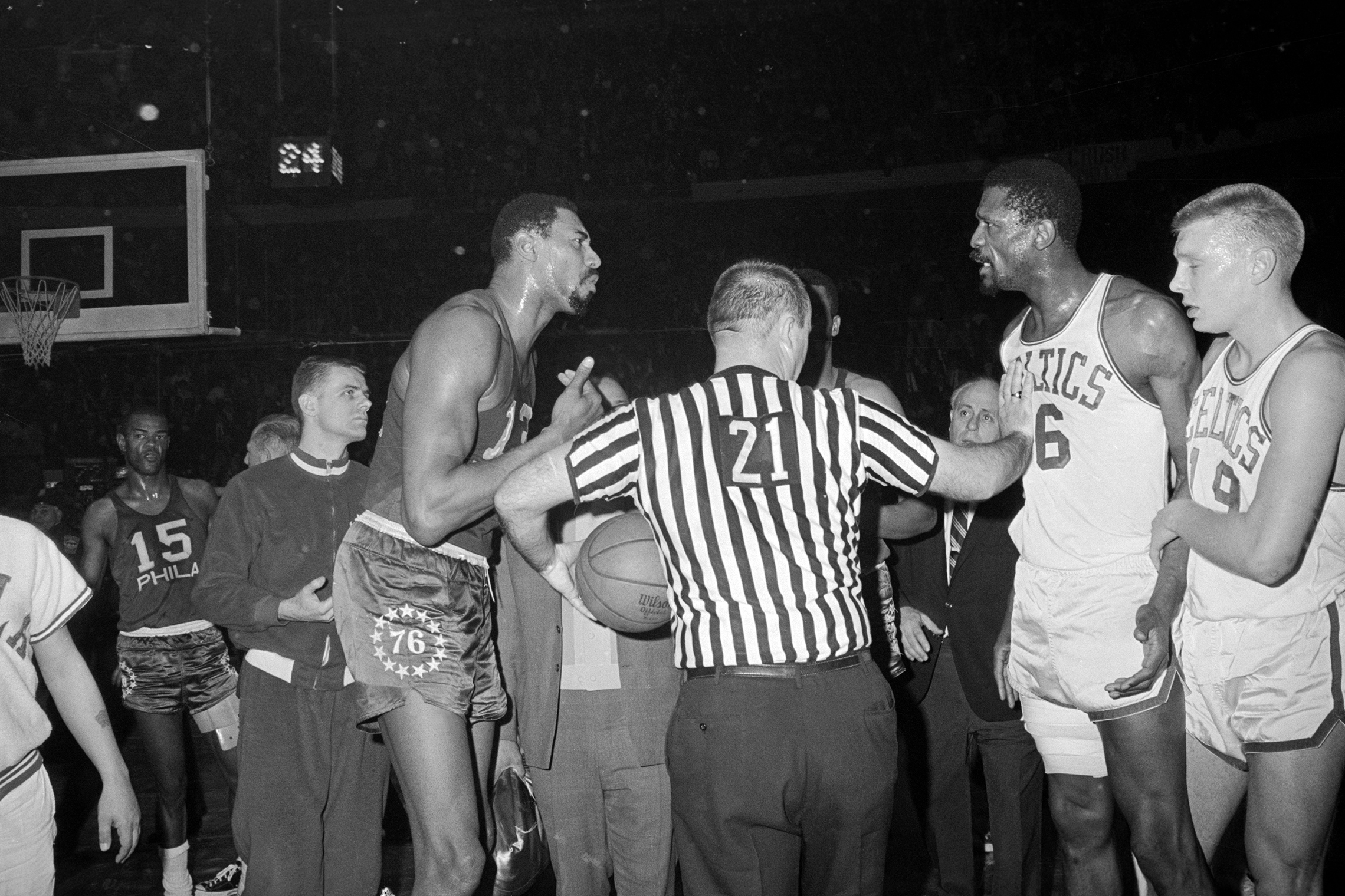 Friends in everyday life, Wilt Chamberlain (L) and Bill Russell (R) were fierce competitors on the basketball court. The referee restrains Russell during a heated exchange at the 1966 Eastern Division finals. (© Bettmann/CORBIS)