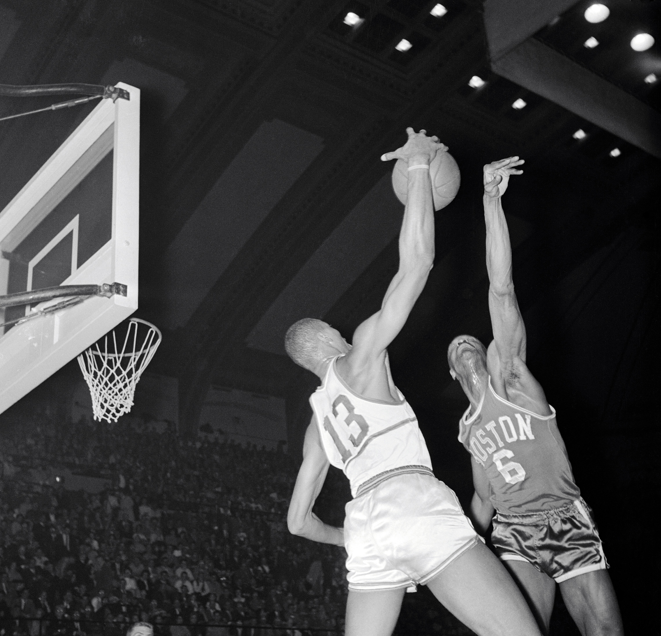 The 1959-60 season was the first in the most famous rivalry in basketball. Wilt Chamberlain (L), playing for the Philadelphia Warriors, takes the ball from Russell in this 1960 game. Russell's Celtics prevailed over Chamberlain's Warriors in the Eastern Division. (© Bettmann/CORBIS)