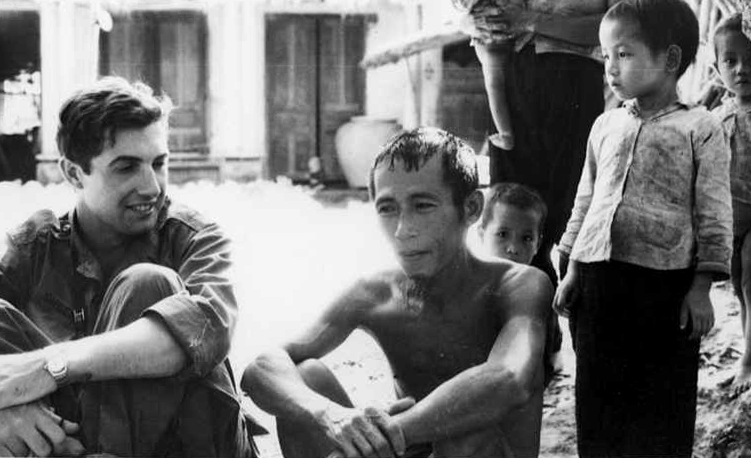 Pulitzer Prize-winning war correspondent Neil Sheehan interviewing villagers in north central Vietnam near Da Nang, Vietnam, 1966.