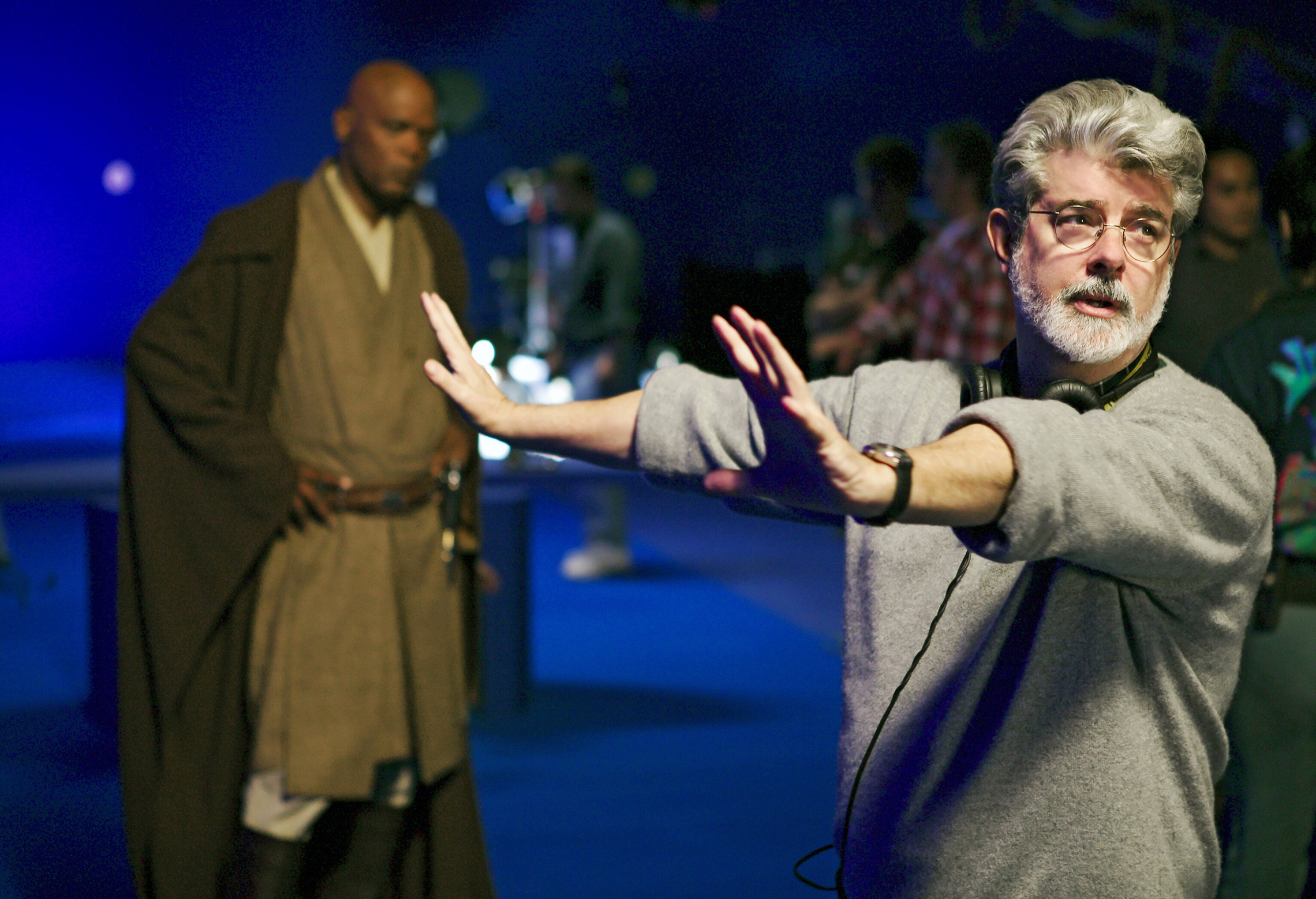 Star Wars Director George Lucas frames a scene for Star Wars: Episode III – Revenge of the Sith (2005), while actor Samuel L. Jackson (as Jedi Mace Windu) looks on. (Lucasfilm Ltd./Photofest/Photographer: Merrick Morton)