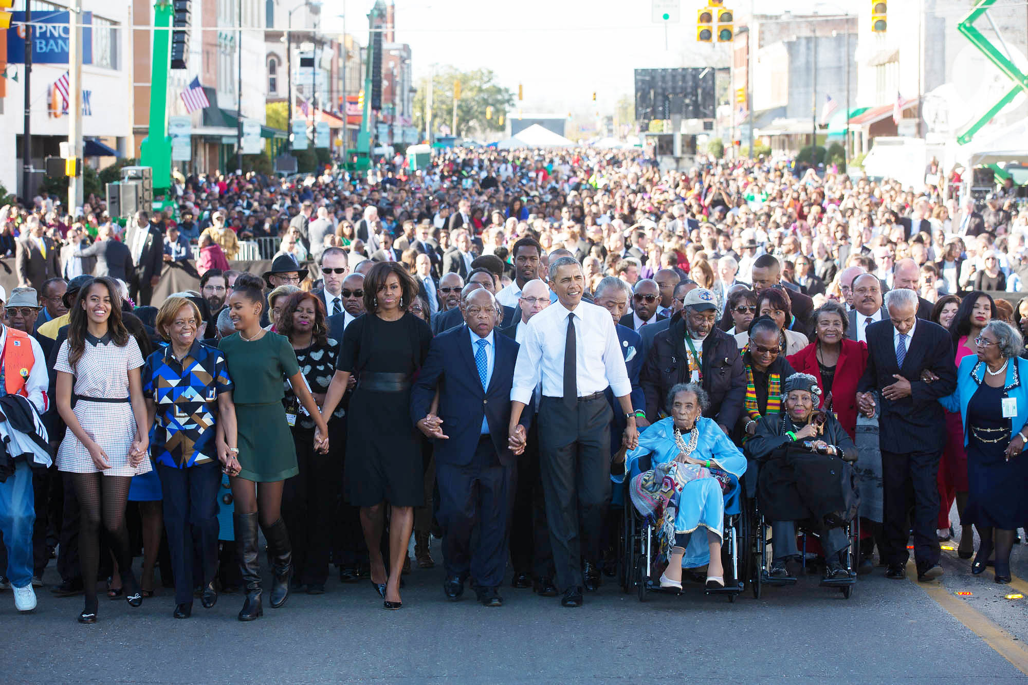 March 8, 2015: President Barack Obama, First Lady Michelle Obama and daughters Sasha and Malia wait with former President George W. Bush, former First Lady Laura Bush prior to the walking across the he Edmund Pettus Bridge to commemorate the 50th Anniversary of the Selma to Montgomery civil rights marches, in Selma, Alabama, March 7, 2015. (Official White House Photo by Lawrence Jackson)