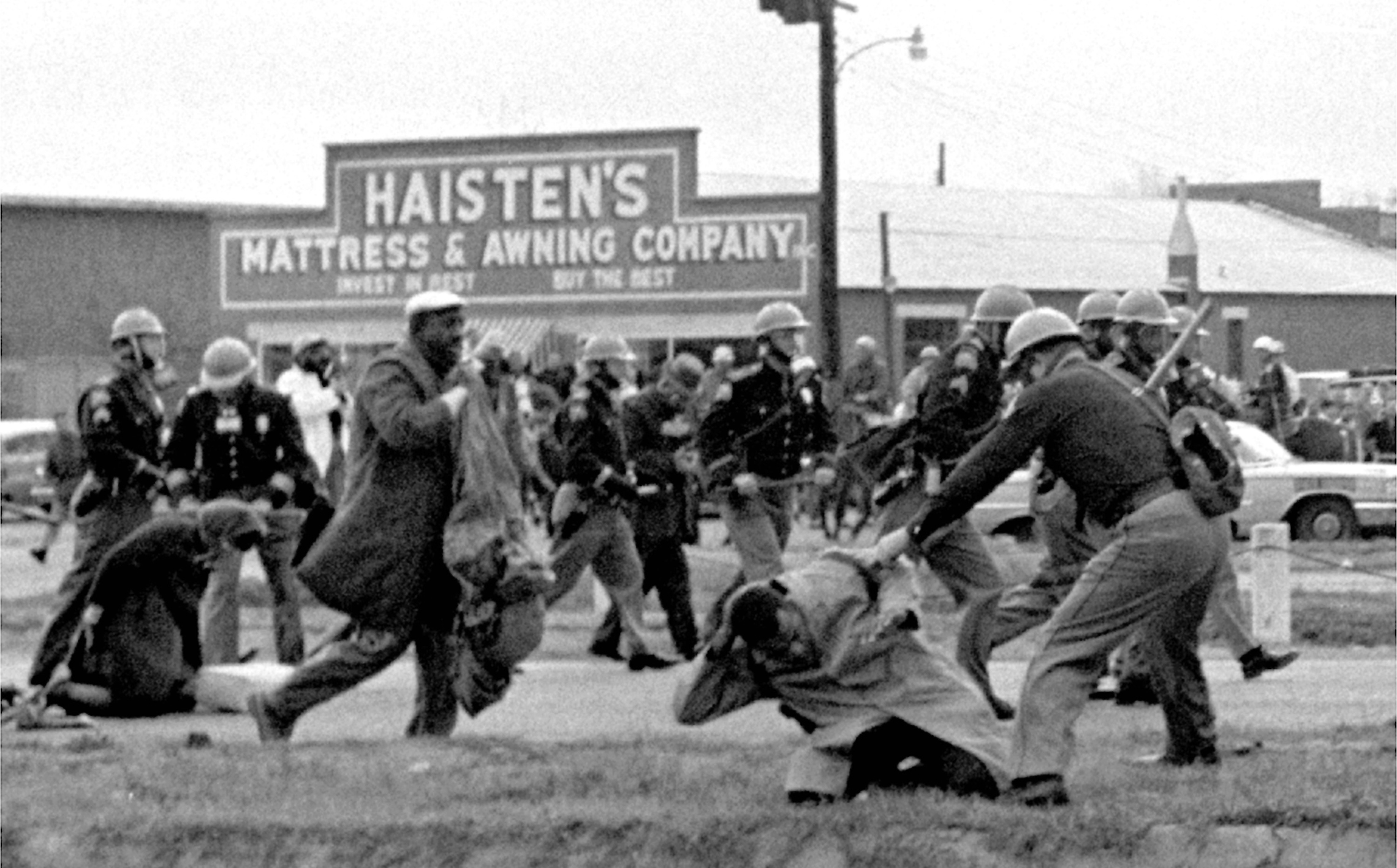 State troopers use clubs against participants of a civil rights voting march in Selma, Alabama, March 7, 1965. At foreground right is John Lewis, Chairman of the Student Nonviolent Coordinating Committee, who is beaten by a state trooper. The day, which became known as "Bloody Sunday," is widely credited for galvanizing the nation's leaders and ultimately yielding passage of the Voting Rights Act of 1965. (AP Photo/File)