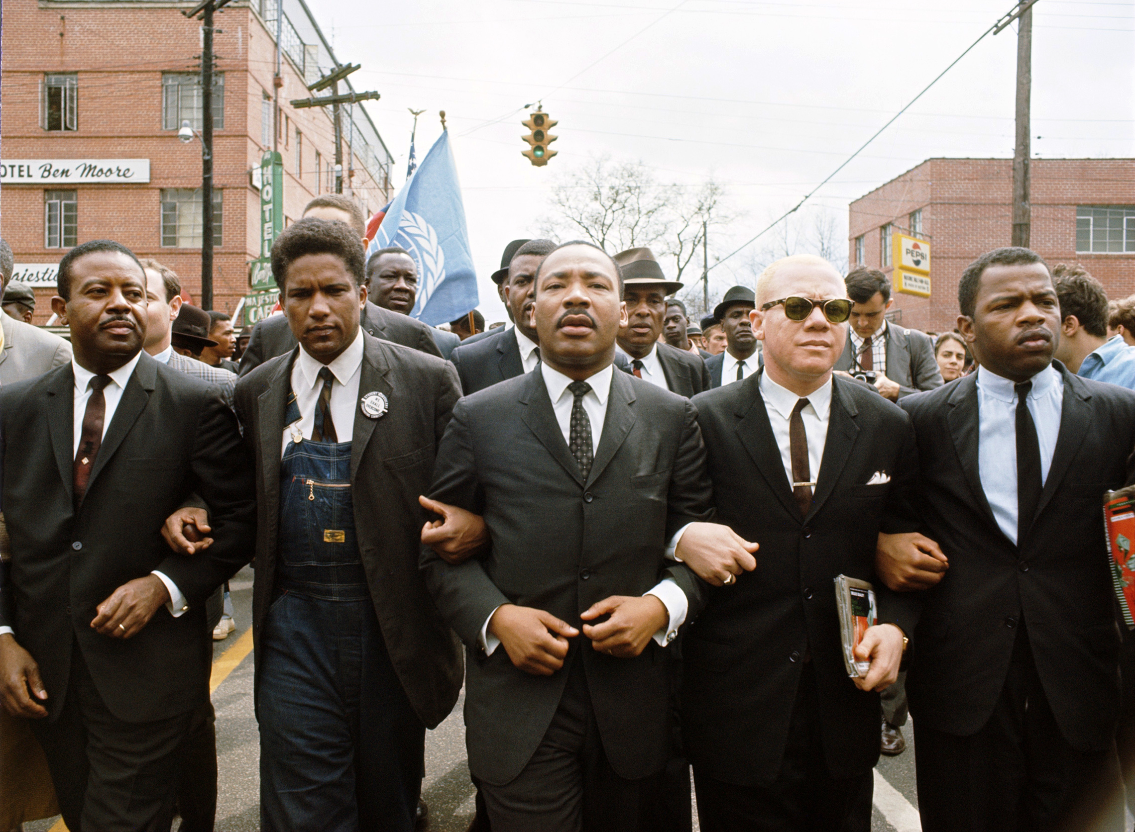 In 1965, John Lewis (far right) with Dr. Martin Luther King, Jr. (center) leads a march in Alabama from Selma to Montgomery, Alabama to protest the denial of voting rights to African Americans. (© Steve Schapiro/Corbis)