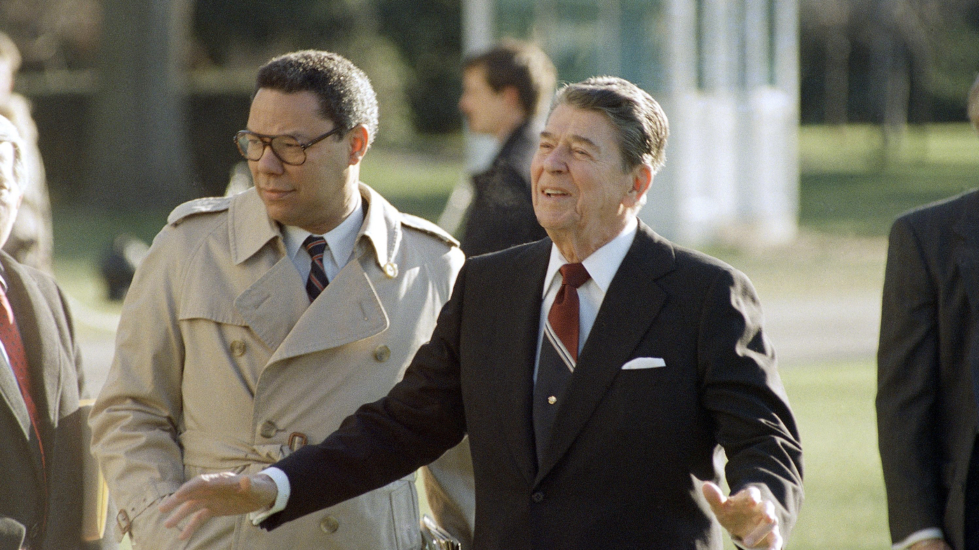 December 16, 1988: Colin Powell, during his time as National Security Advisor, accompanies President Reagan as he leaves the White House. (Barry Thumma/AP)