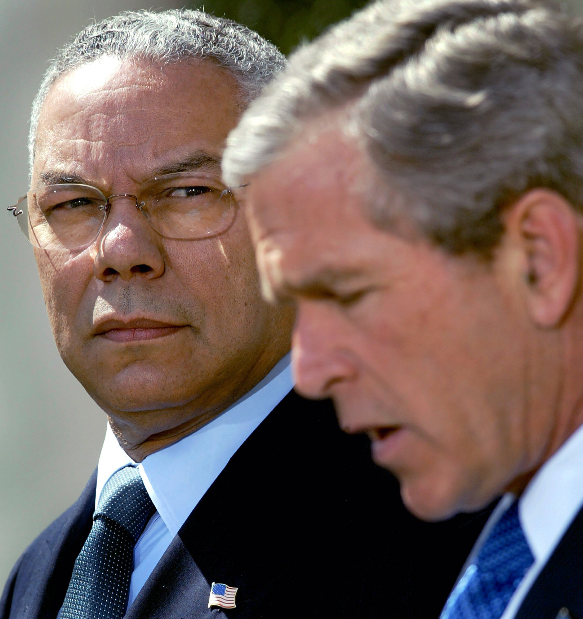 April 4, 2002: Secretary of State Colin Powell looks on as President Bush makes a statement in the Rose Garden of the White House. (AP Photo/Doug Mills,File)