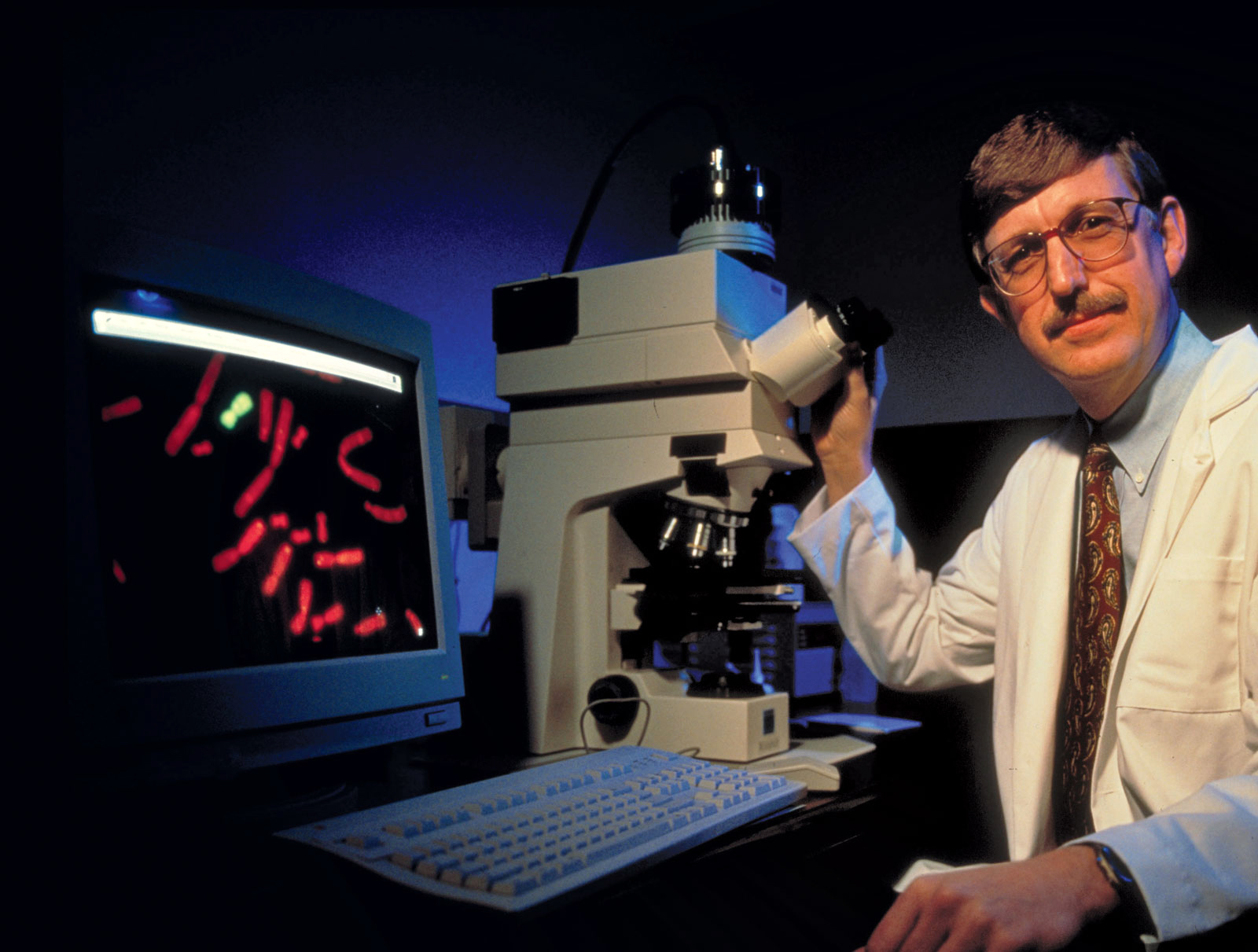 1993: Geneticist Dr. Francis Collins at microscope and computer, mapping human genes, working in the National Institutes of Health lab. (Photo by Ted Thai/The LIFE Picture Collection/Getty Images)