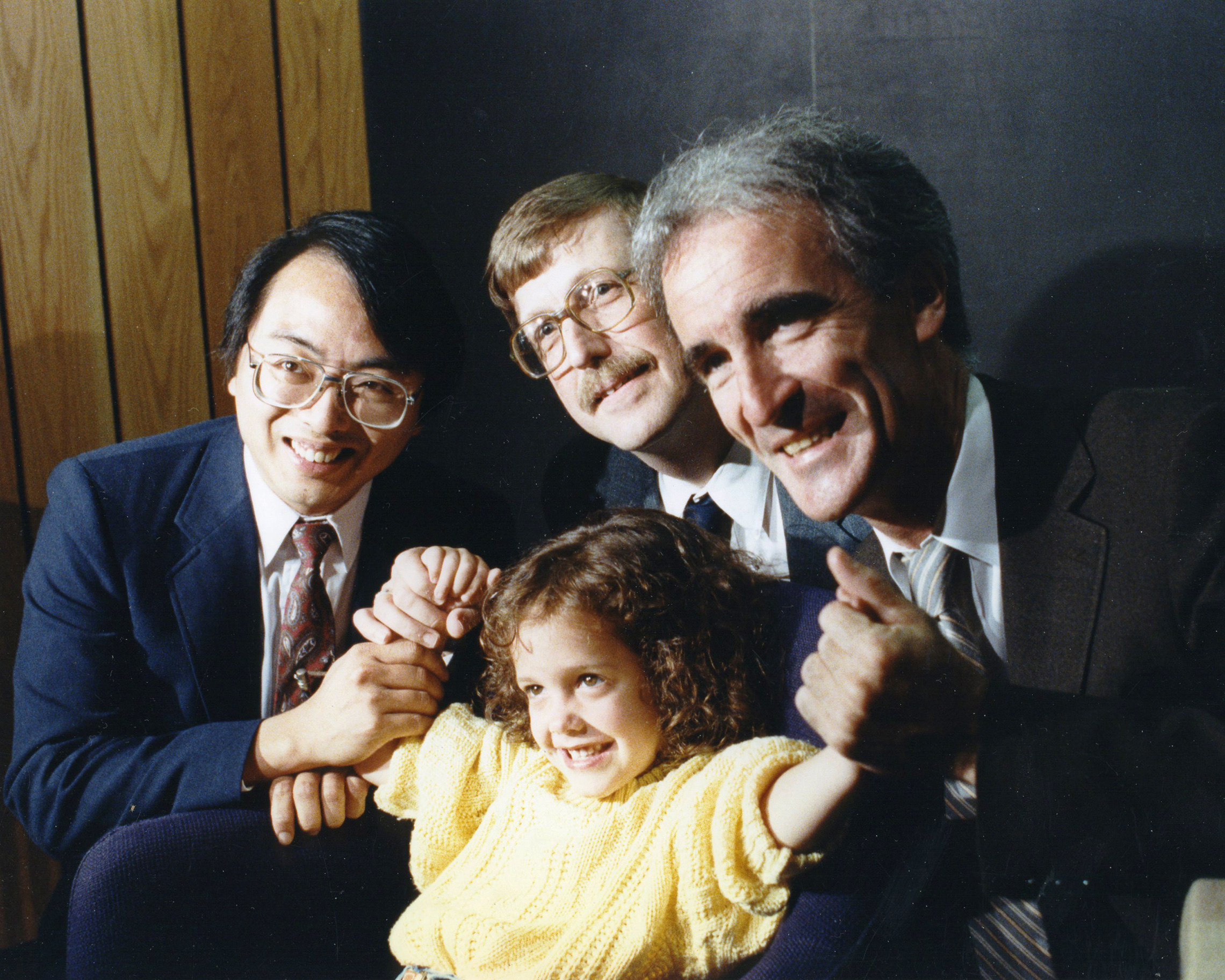 Lap-Chee Tsui, Francis Collins and Jack Riordan (left to right) celebrate their 1989 discovery of the cystic fibrosis gene with a patient. (Canadian Cystic Fibrosis Foundation)