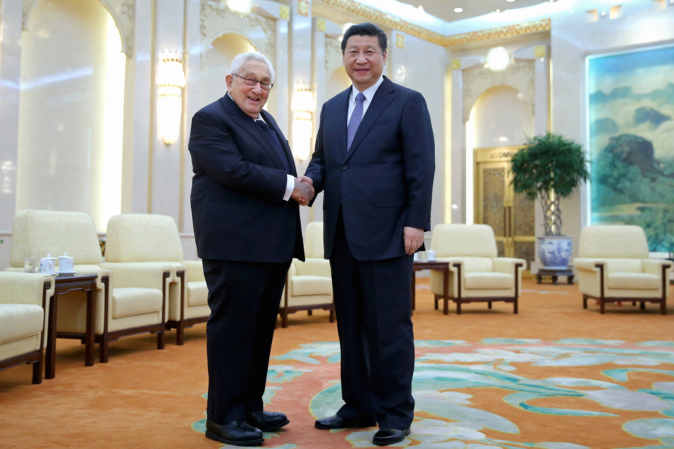 Março 17, 2015: O Presidente chinês Xi Jinping aperta a mão ao antigo Secretário de Estado dos Estados Unidos Henry Kissinger no Grande Salão do Povo em Pequim, China. (Foto de Feng Li - Pool/Getty Images)