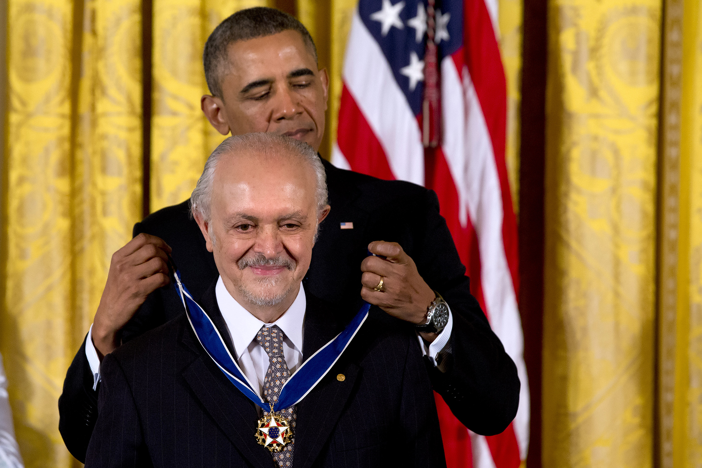 President Barack Obama awards chemist, and Nobel Prize laureate Mario Molina with the Presidential Medal of Freedom, Wednesday, Nov. 20, 2013, during a ceremony in the East Room of the White House in Washington. (AP Photo/Jacquelyn Martin)